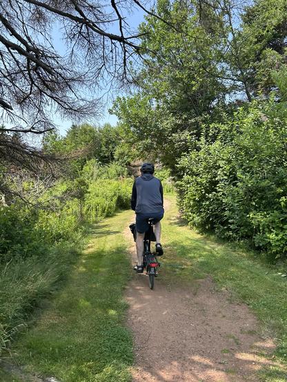 Brompton bike pretending to be a gravel bike on a red dirt path in PEI