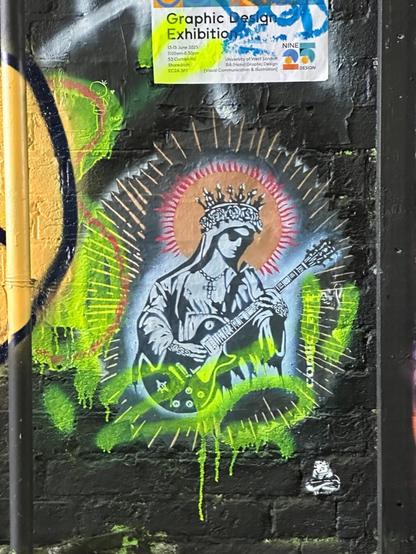 a stencil of a saint/BVM figure, only wearing sunglasses and playing an electric guitar