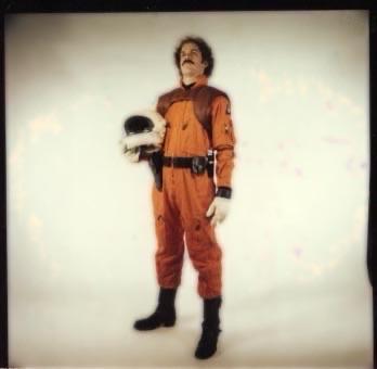 Me in orange flight gear holding my helmet, 1983.