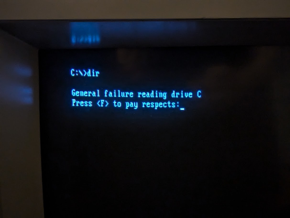 Photo of a CRT monitor with the following DOS message C:>dir  General failure reading drive C Press <!-- raw HTML omitted --> to pay respects: