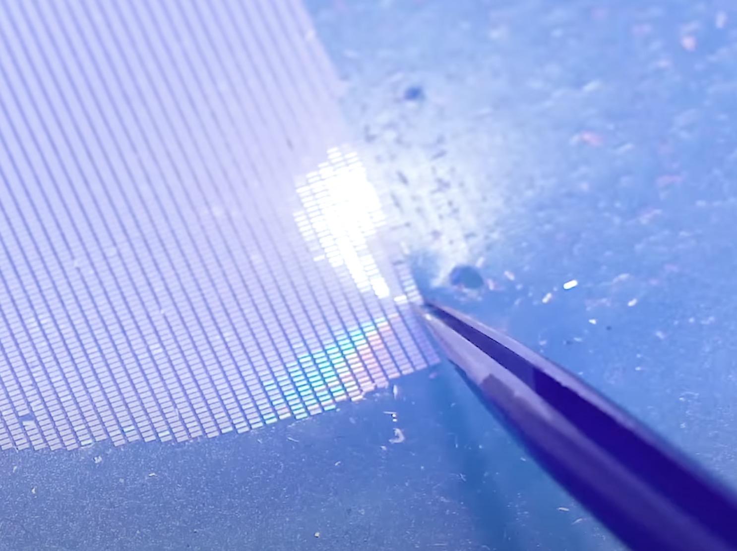 a wafer of teeny tiny LEDs that a worker is using a tweezer to pull one off and manually place on a strip. Earlier in the video there’s a pick and place machine doing thing about 3000% faster