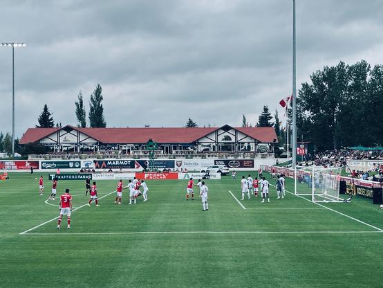Cavalry FC and York Utd players waiting for a corner kick, eastern end of ATCO field at Spruce Meadows.