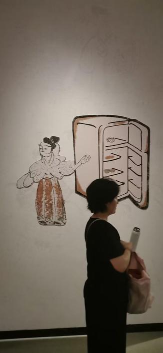 展厅内的墙纸,图案为一身穿襦裙女人举左臂指向一冰箱