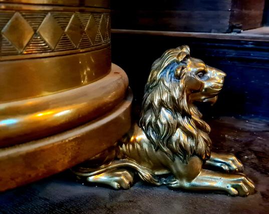 A brass lion forming the foot of a lecturn in a Victorian church.
