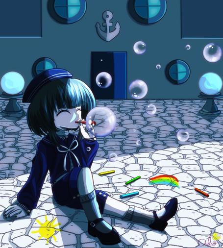 Minami sat in front of his house on the cobblestone ground. He is blowing bubbles and has chalk scattered around him with some drawings he did - a rainbow and a sun.