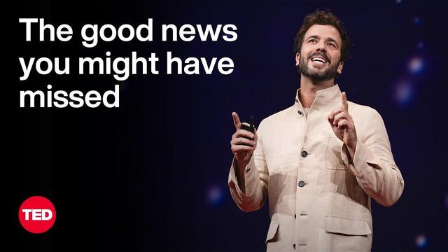 Screenshot from the first linked TED talk. A rather young man stands on the right sight, smiling and gesticulating in explaining something. He is dressed in white, has dark hair and a beard. To the left, white letters read, ‘The good news you might have missed’, and below that, bottom left, there’s the TED logo, a red circle with the white capitalised letters ‘TED’. The background is dark-blue  and blurred.