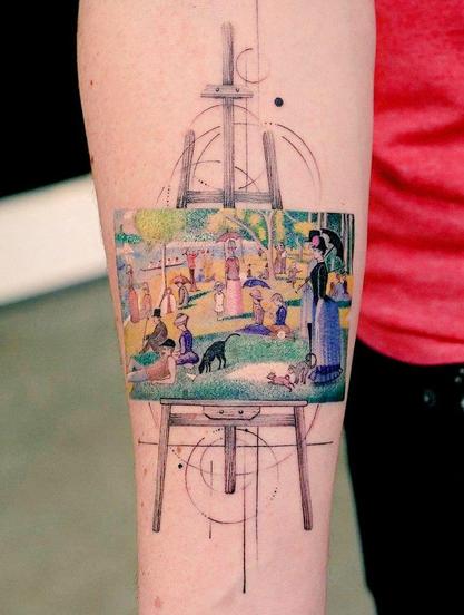 The tattoo in the image depicts Georges Seurat's famous painting, "A Sunday Afternoon on the Island of La Grande Jatte".
The painting portrays Parisians enjoying leisure time in a park on the banks of the River Seine, specifically on the Island of La Grande Jatte. 