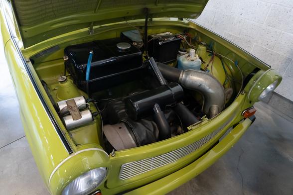 A look inside the engine bay. You can barely make out an engine between its fuel tank and air intake manifolds.