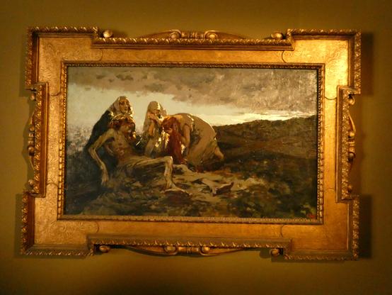 Dramatically lit painting, showing Jesus removed from the cross