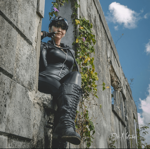 SJ Slays as Catwoman sitting from a high vantage point.