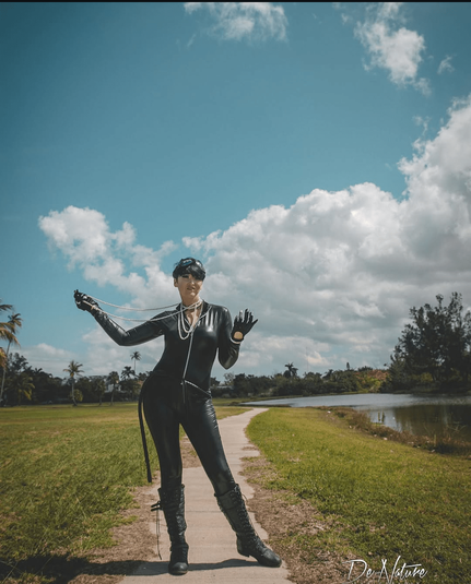 SJ Slays as Catwoman clutching a pearl necklace.