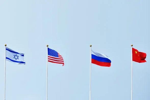 Four national flags displayed on poles: Israel, the United States, Russia, and China against a clear blue sky. /Getty Images