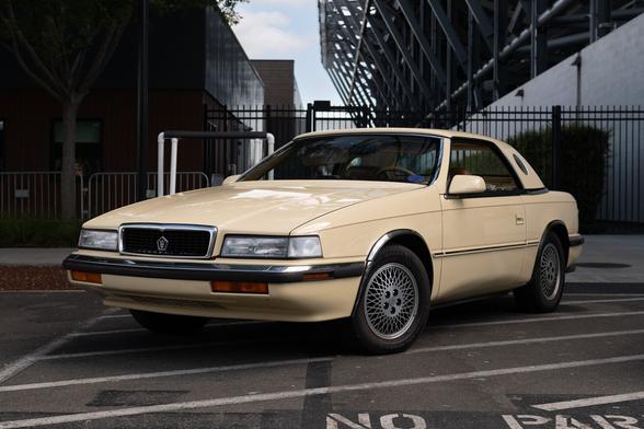 An late 1980s tan coupe with its hardtop on.