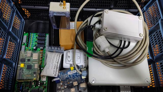 A box full of older hardware like Raspberry Pis and some LoRaWAN devices