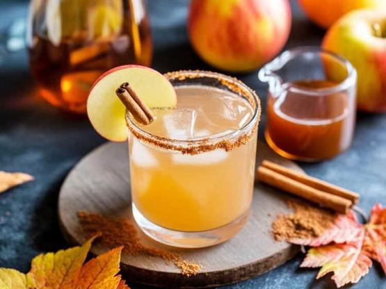 Spiced Apple Cider Margarita cocktail with cinnamon sugar rim and apple slice
