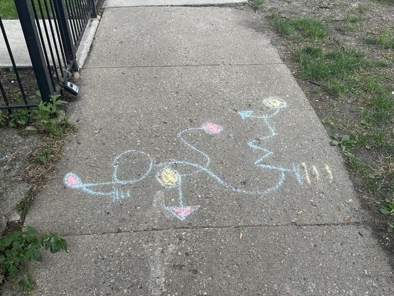 A strange chalk sigil on the sidewalk