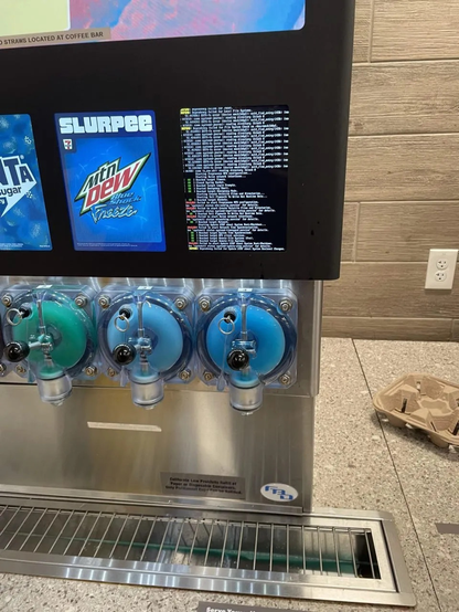 A slurpee machine at 7/11 but one of the electronic screens that displays a crashed bios screen