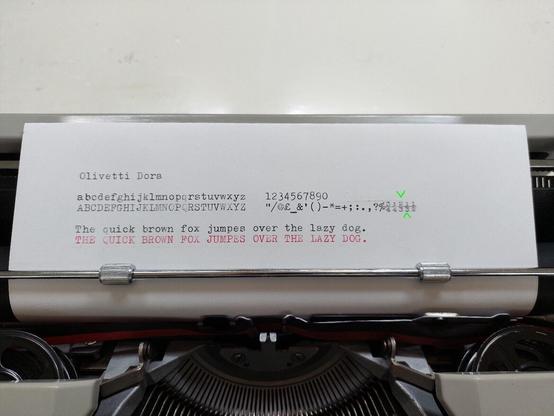 Sample of typewriter output, with the page still in the typewriter. A complete alphabet is shown as well as numbers, fractions, punctuation and symbols.