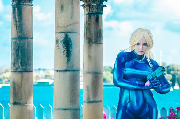SJ Slays as Samus Aran from Metroid holding prop weapon.