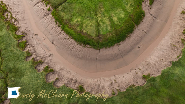 Aerial view of a 90 degree bend in a river.
