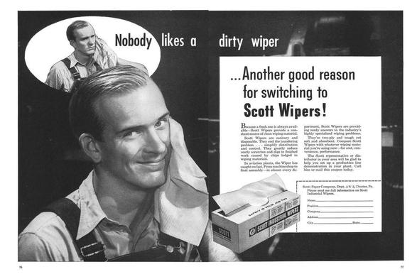 The advertisement is a black and white image, typical of mid-20th-century print advertising. It's divided into several sections. Main Focus: The central figure is a smiling man with neatly combed hair, wearing a light-colored, collared shirt and dark suspenders. He's holding and using a white Scott Industrial Wiper, which is prominently displayed. His expression is one of contentment and satisfaction. The wiper is clean and appears soft.

    Thought Bubble: A smaller image within a thought bubble to the upper left shows another man, looking displeased and wiping his brow with a soiled, dark-colored rag. The text within the thought bubble reads "Nobody likes a dirty wiper" which directly contrasts with the image of the satisfied man. This comparison is the core marketing message.

    Product Display: A box of Scott Industrial Wipers is visible next to the main image. The box is clearly labeled with the brand name and imagery that emphasizes hygiene and safety. The text on the box states "SAFETY IS YOUR JOB TOO."

    Text: The advertisement text highlights the advantages of Scott Wipers: their cleanliness, disposability, cost-effectiveness, and efficiency compared to traditional rags or other wiping materials. There is also a coupon at the bottom for the reader to request more information, including a space for name, position, company, address, city, and state.