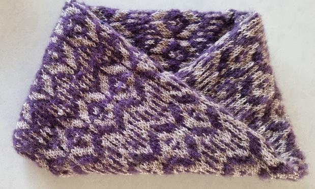 A finished Mobius Strip Cowl... coloured with purple mohair and grey fingering hand-dyed yarn.
Pattern with fair-isle zigzags, dots, and lines