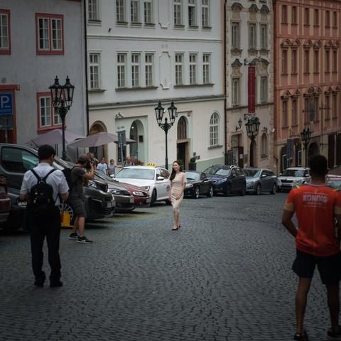 Photo of asian tourists taking selfies in the streets in Prague