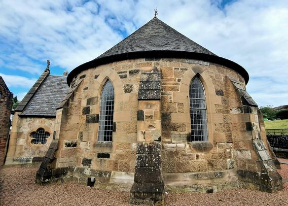 An unusual blonde sandstone church is a semi-circular end.