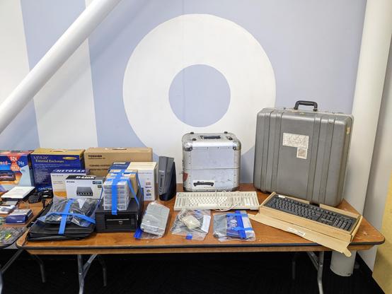 One of my tables in the consignment area at VCFW: DAt tapes & drive, keyboards, SUNstation, travel cases, and other retro and vintage computing items
