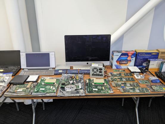 Another of my tables in the consignment room, with an iMac and other apple Macintosh boards, new in the box CDRW and external drive case, video capture cards, etc