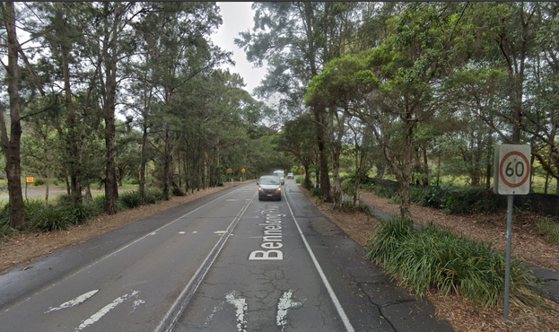 Screenshot from Google Streetview showing the not-a-crossing shared use path crossing of Bennelong Parkway from a bit further away, so you can see the sign that increases the speed limit to 60 kph about 20 metres before the not-a-crossing.