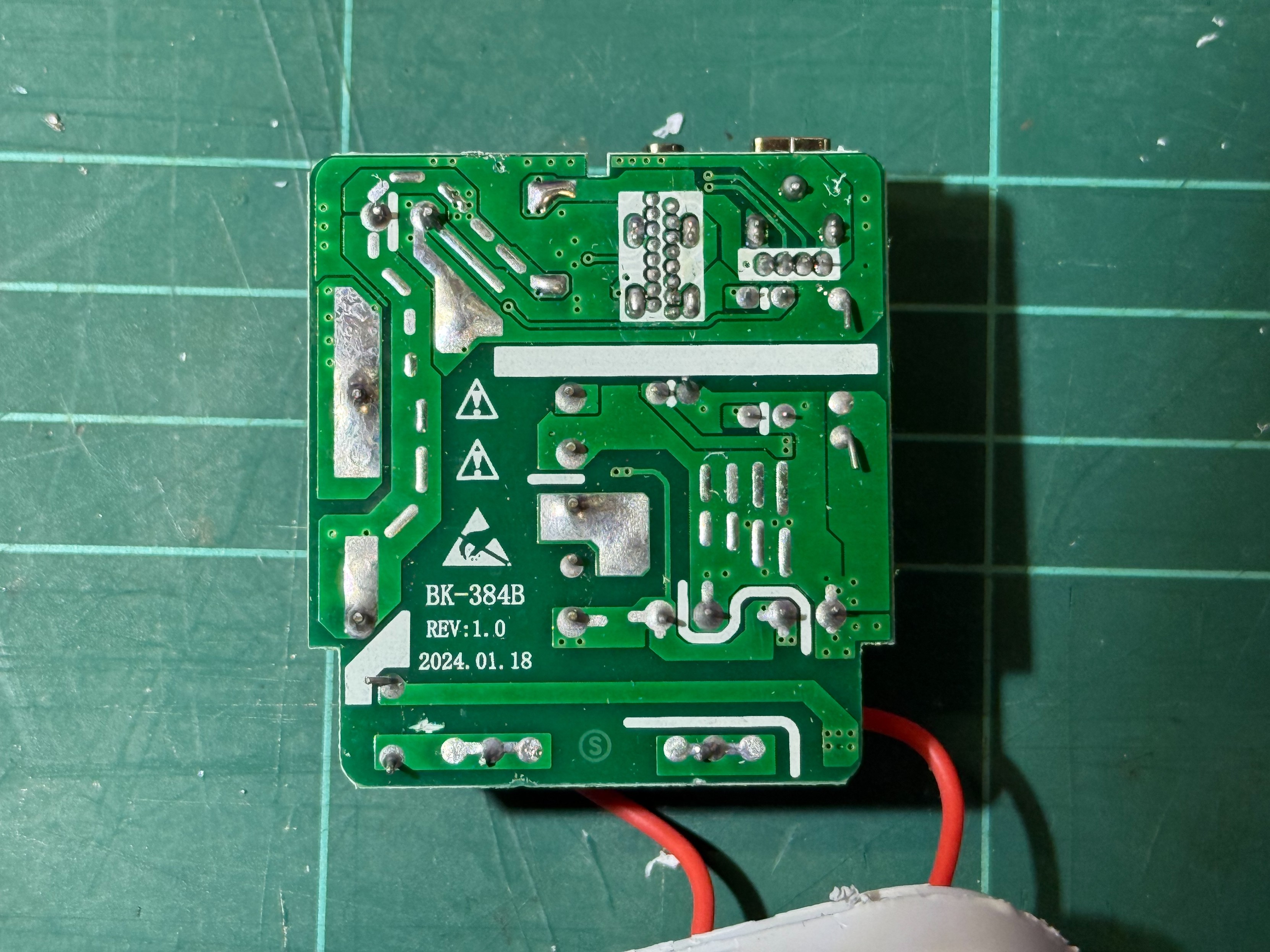 The underside of the PCB, showing clearly marked isolation barriers with silkscreen, antistatic warning symbol, and the model BK-384B