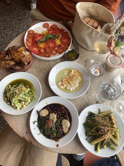 Table filled with small plates of interesting food