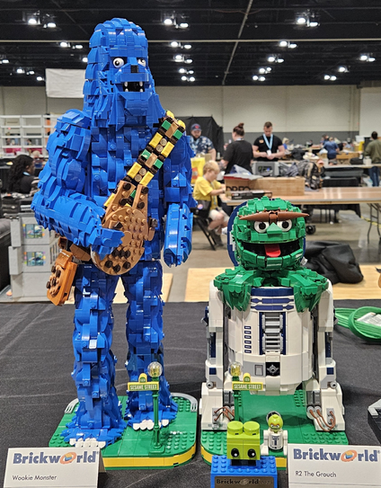 LEGO model resembling Chewbacca but with blue bricks and holding a cookie, next to the model entitled, "R2 the Grouch"