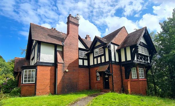 A pair of Arts and Crafts style late Victorian semi-detached cottages.