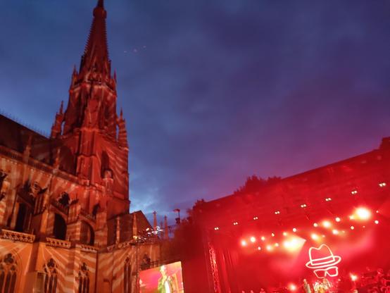 Die Konzertbühne neben dem Mariendom. Beides ist grellrot beleuchtet.