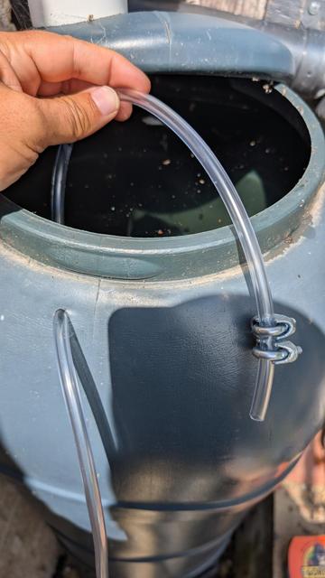 Step 2: insert clear pipe with length 3* height of water butt. Attach weight to interior end of pipe so it sinks to bottom