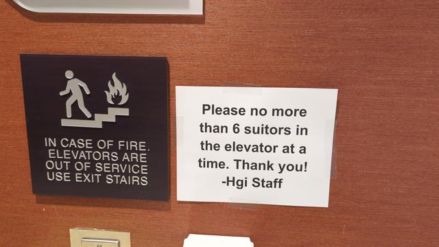 A sign by the hotel elevator which reads:

"Please no more than 6 suitors in the elevator at a time. Thank you! -Hgi Staff"

The intent being no more than 6 suiters (fursuiters) in the elevator at once.