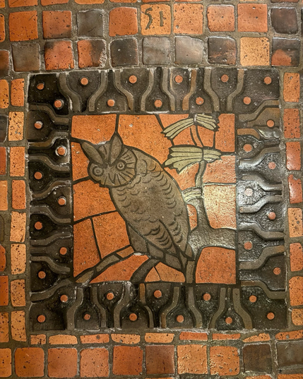 photo of the screech owl tile floor mosaic, numbered 51 square with thick ornamental frame