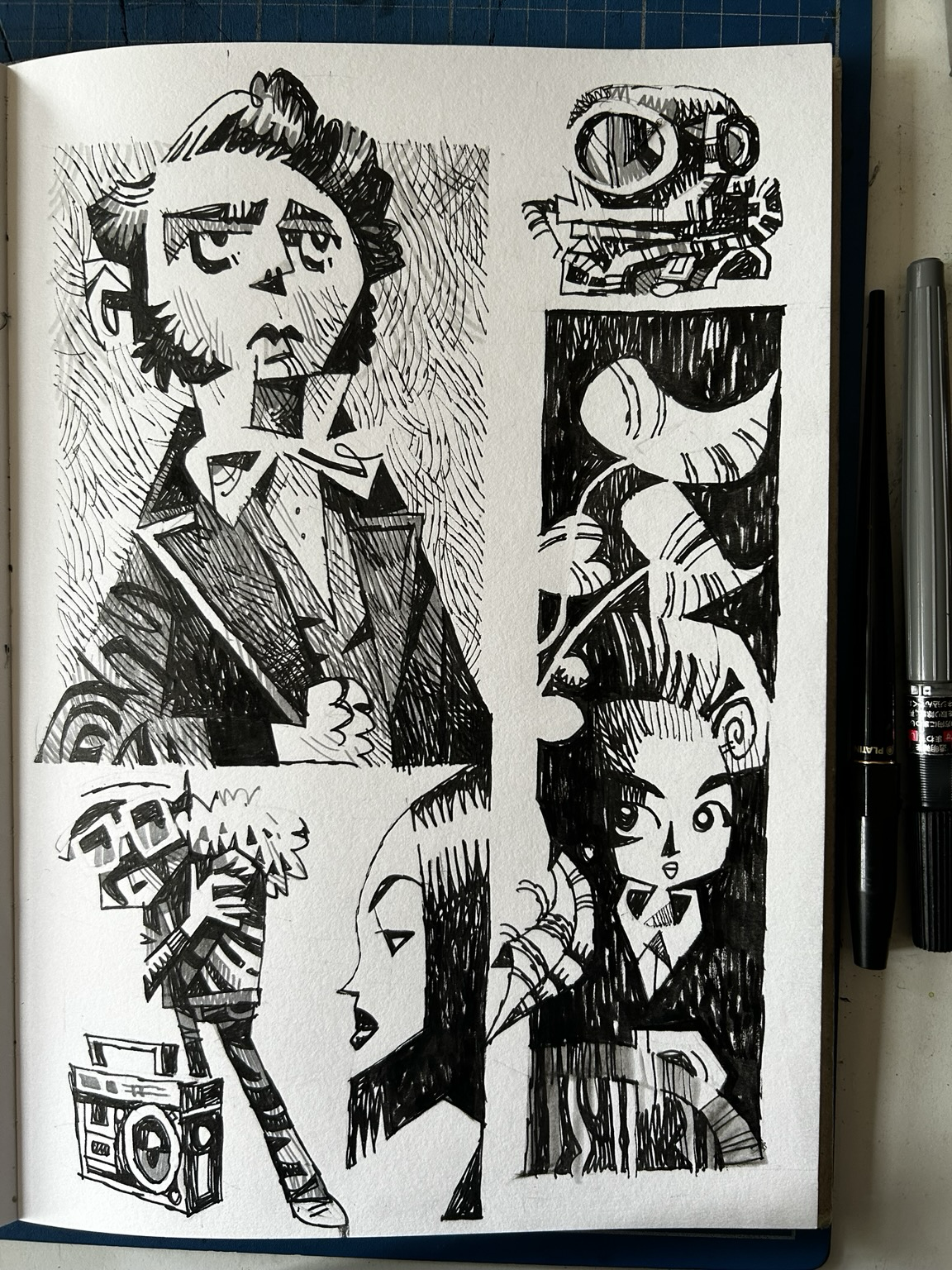 A selection of black and white drawings in a sketchbook
