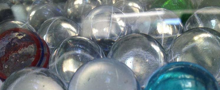 Marbles - with a red, blue and green one, at a distance.