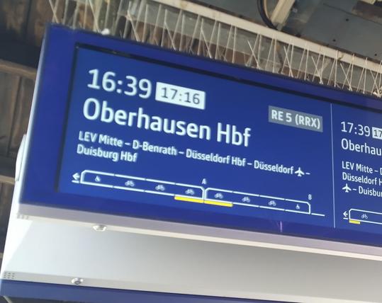 Picture of an electronic sign announcing that the 16:49 train will arrive 17:16