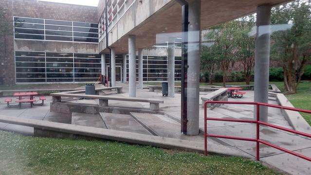 A picture of my old high school, which I got the chance to explore for the first time in over fifteen years. This is an outdoor seating area where my friends I and spent much time.