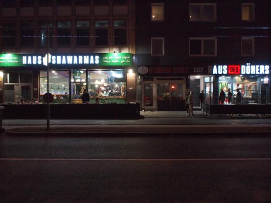 Neon lights of a shawarma and a kebap shop.