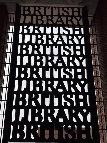 British Library sign repeating the words ‘British’ and ‘Library’ in a metal lattice (words repeated six times on top of each other) in giant rectangle about 3m tall.