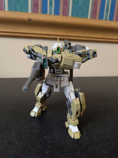 The HG Demi-Barding aiming its beam rifle and one of its backpack cannons at the viewer while stepping forward