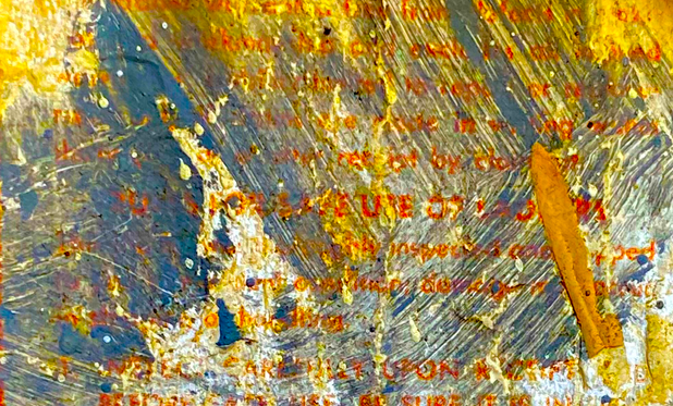 an occasional legible warning label obscured by a combination of age and brush strokes of various paints - dark blues, oranges, yellows, whites. What's visible of the original text is in orange.