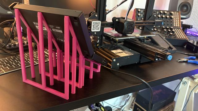 Back view of pink 3D printed holders for my synths, where it's visible how they prop up the semi modular little module thingies.