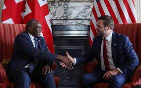 UK foreign sec David Lammy sat in front of union flags smiling and shaking hands with US vice president JD vance who is sat in front of USA flags. No assurances about the safety of couches have been made.