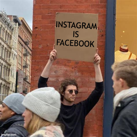 guy wearing sunglasses holding up a cardboard sign in front of a crowd of passers-by which reads INSTAGRAM IS FACEBOOK